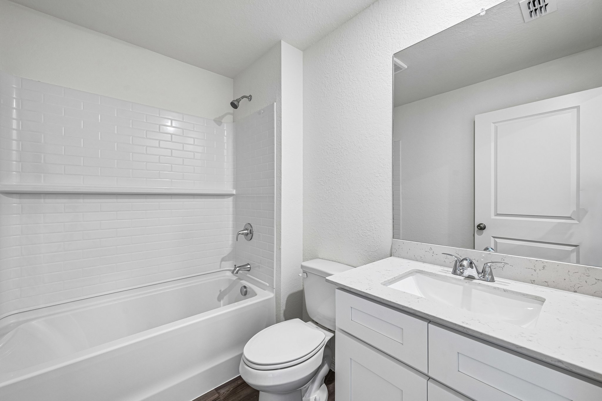 A bathroom with a tub sink and toilet.