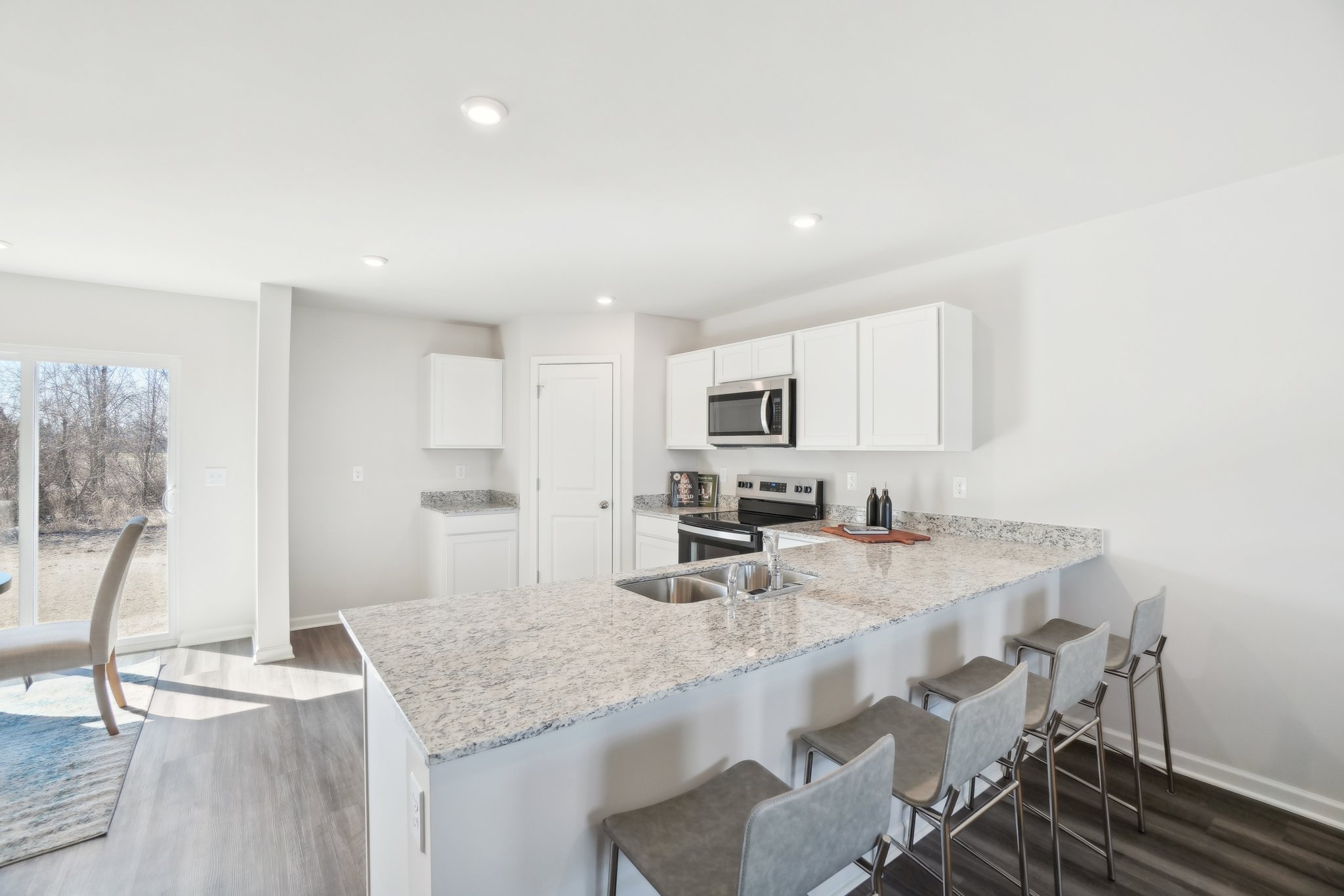 A kitchen with a marble island.