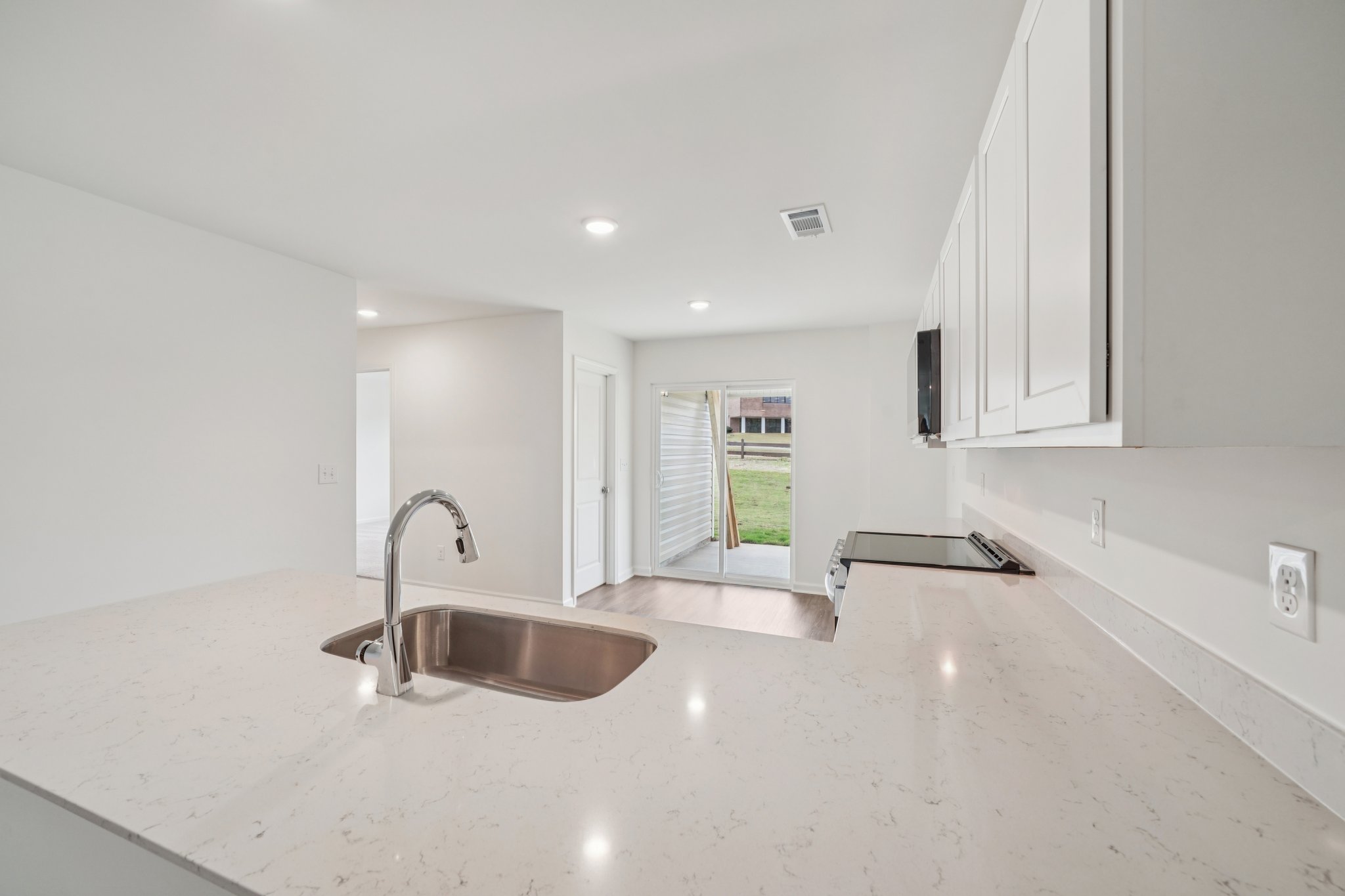 A large bathroom with a sink and a large window.