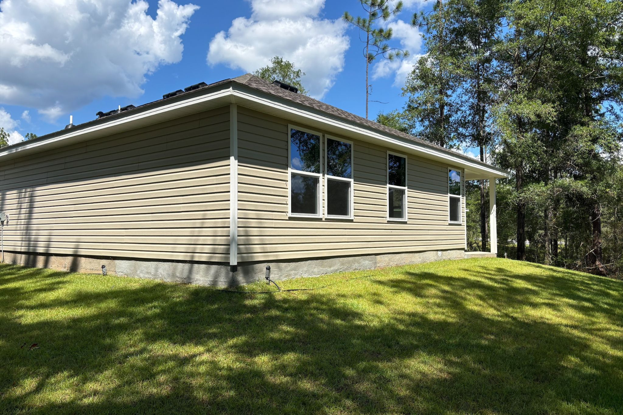 A house with a lawn in front of it.