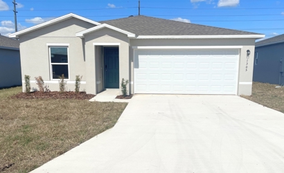 A white house with garages.